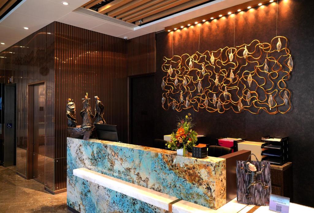 a lobby of a restaurant with a reception desk at E Hotel Hong Kong in Hong Kong