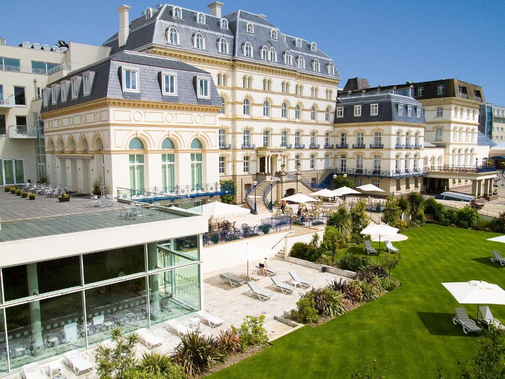a large building with a lawn in front of it at Hotel de France in Saint Helier Jersey