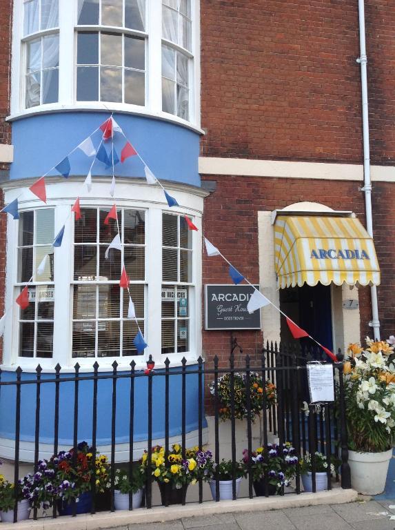 a building with a kite hanging from a fence at Arcadia Guest House in Weymouth