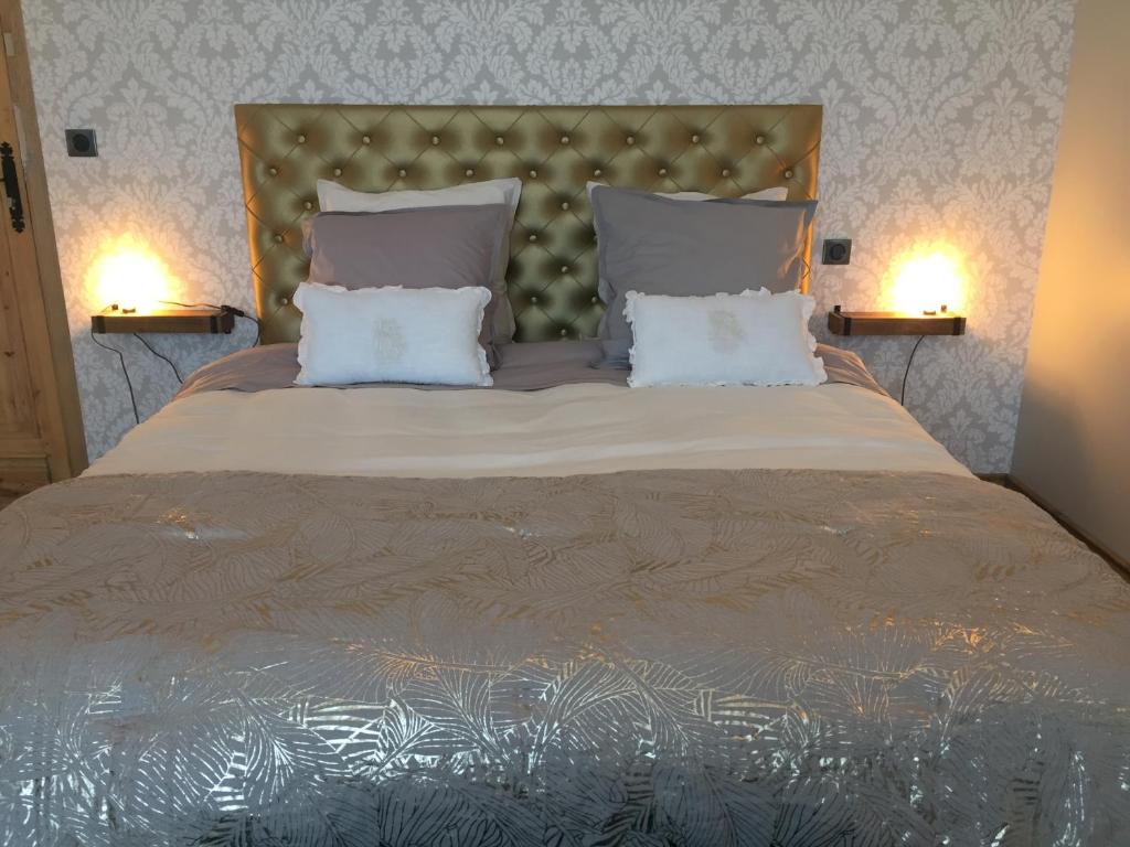 a bedroom with a large bed with two pillows at LA NIEPPOISE in Nieppe