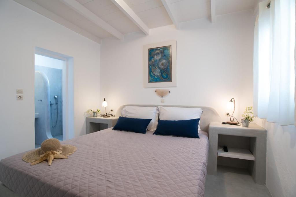 a bedroom with a bed with a teddy bear on it at Krotiri Bay -adults only in Parikia