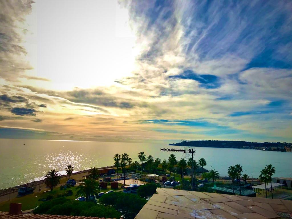 een uitzicht op een waterlichaam met een bewolkte lucht bij Le Bastion in Menton