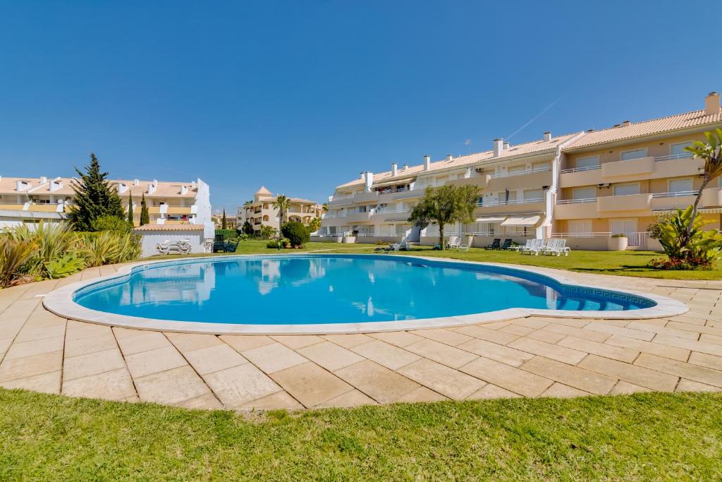 a swimming pool in front of a building at Falésia II - Nice Apartment - Vilamoura in Vilamoura
