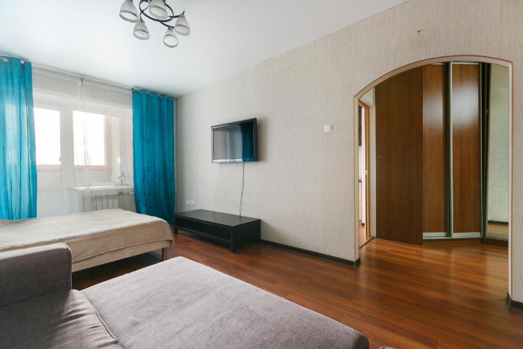 a hotel room with two beds and a mirror at Apartments Freedom in Novosibirsk