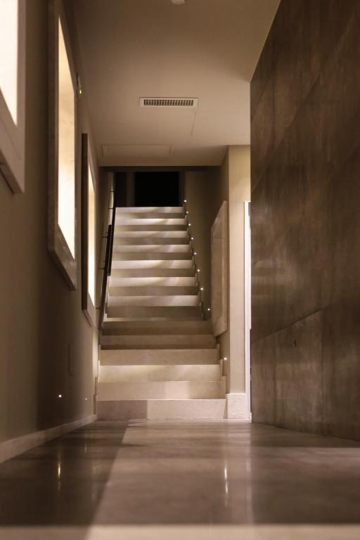 an empty hallway with stairs in a building at Neko Boutique Hotel in Cagliari