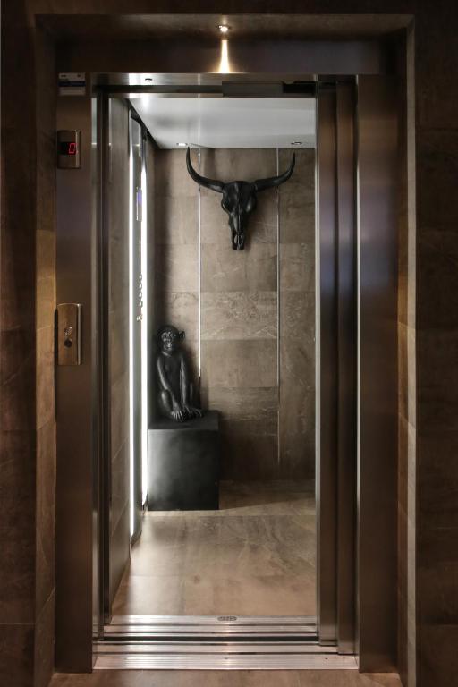 an open door with a bull head on a wall at Neko Boutique Hotel in Cagliari