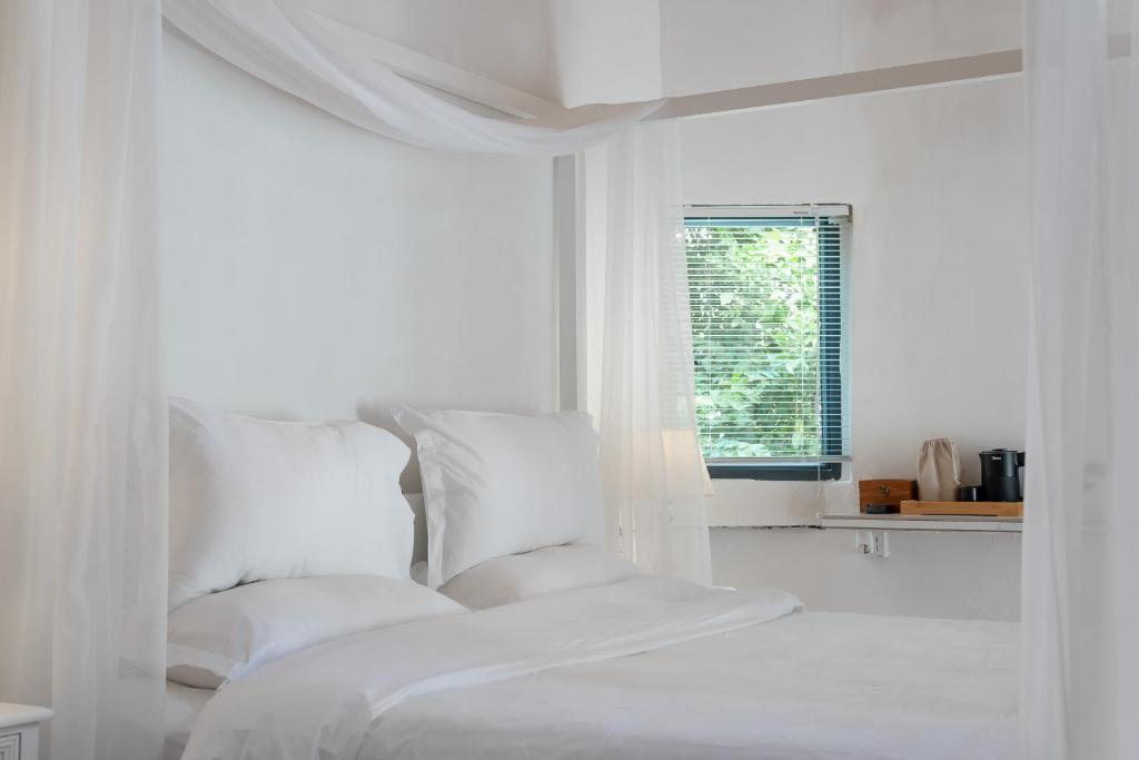 Postel nebo postele na pokoji v ubytování Su Jiu Apartment