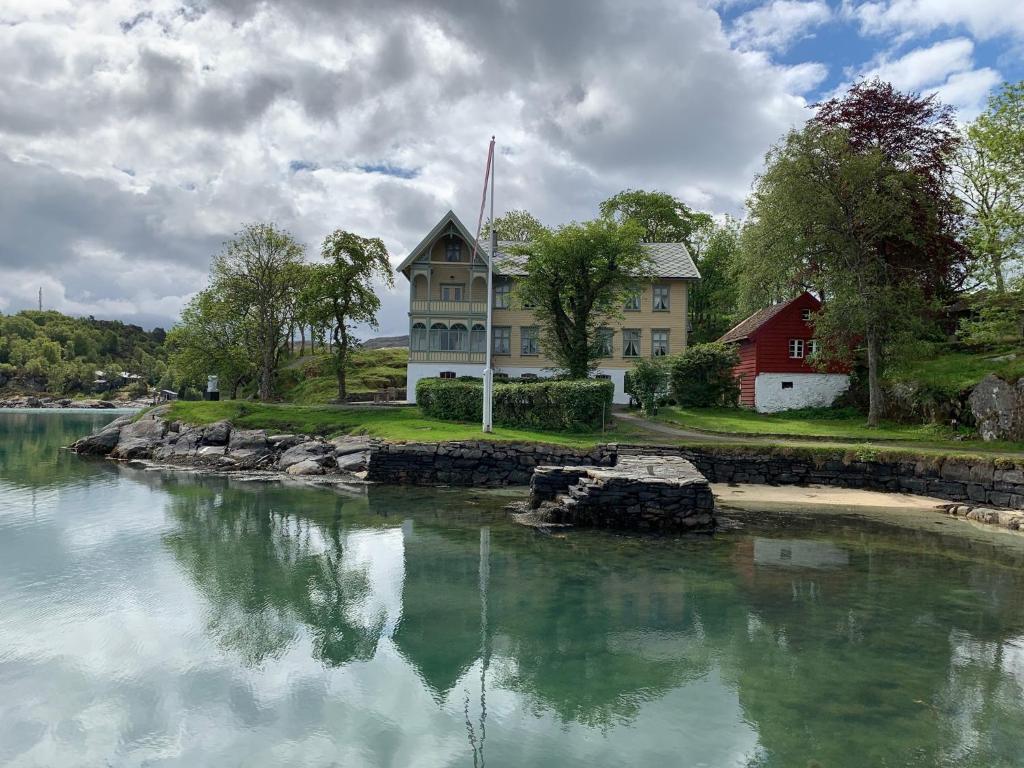 una casa seduta accanto a un corpo d'acqua di Skjerjehamn a Ånneland