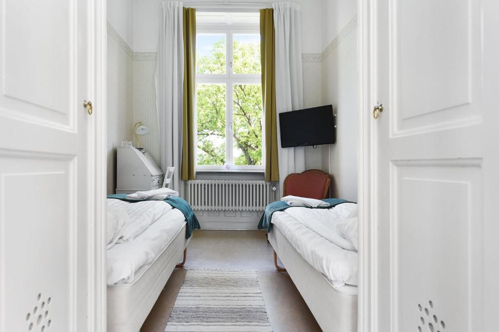 Postel nebo postele na pokoji v ubytování Ersta Hotell & Konferens