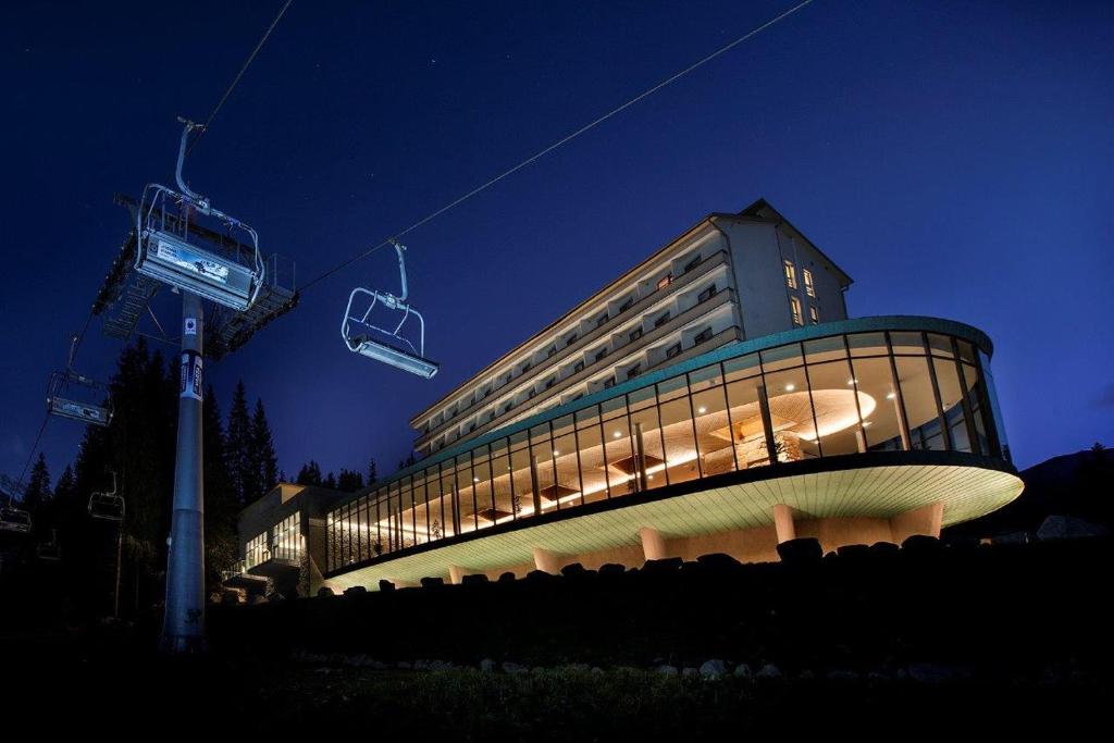 a building with a ski lift in front of it at Hotel SOREA SNP in Demanovska Dolina