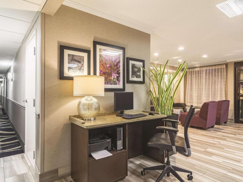 an office with a desk with a computer and a chair at Wingate by Wyndham Brunswick GA I-95 in Brunswick
