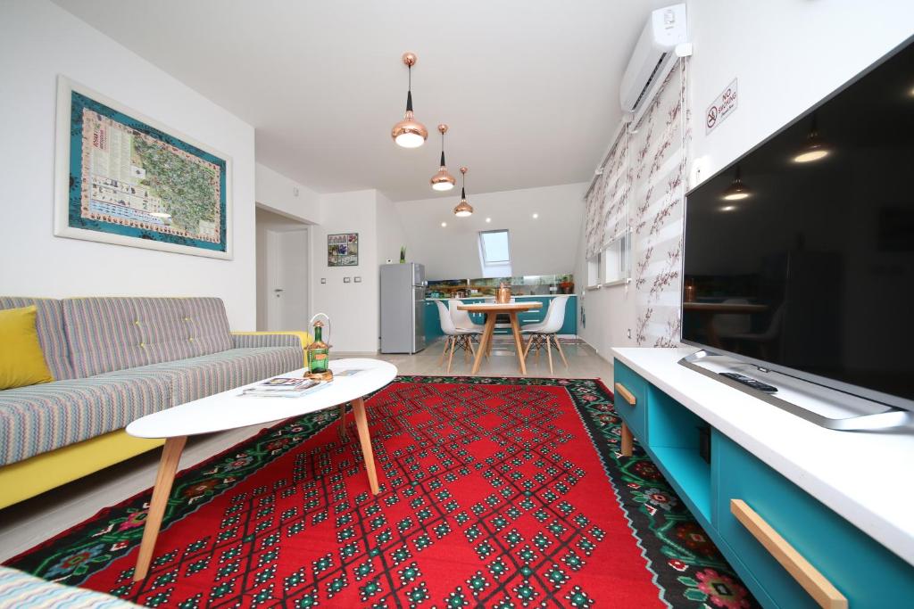 a living room with a couch and a table at Apartment STARI LISAC in Sarajevo