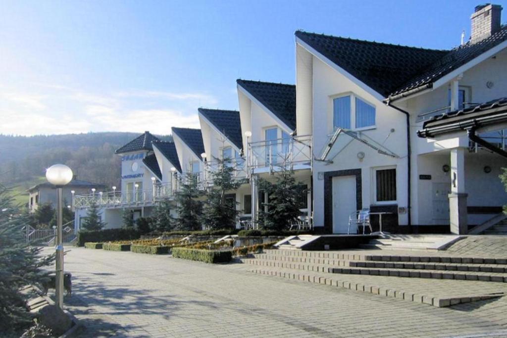 a row of houses on a street with stairs at Apartamenty Solar in Wisła