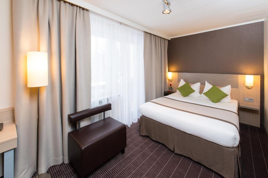 Postel nebo postele na pokoji v ubytování Hotel New Orly