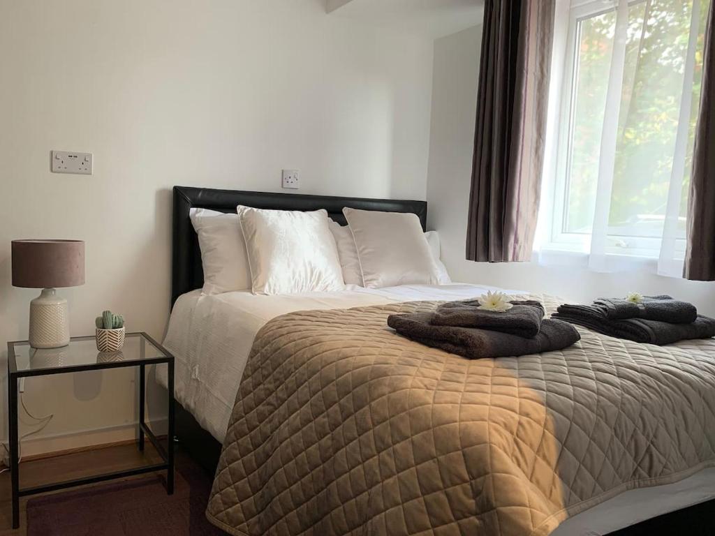 a bedroom with a bed with two towels on it at Serviced Apartment Bristol One-Bedroom Southmead Hospital MOD Airbus in Bristol