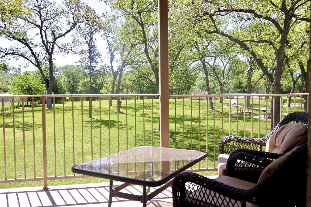 a screened in porch with a glass table and chairs at Guadalupe Getaway in New Braunfels