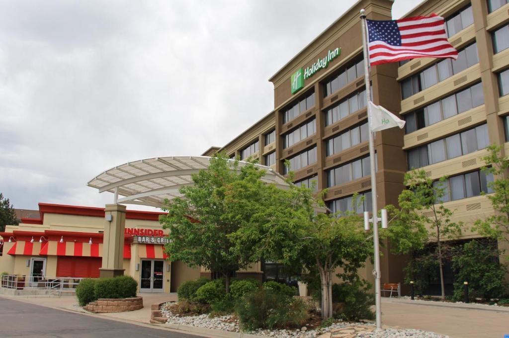 an exterior view of a hotel with an american flag at Holiday Inn Denver Lakewood, an IHG Hotel in Lakewood