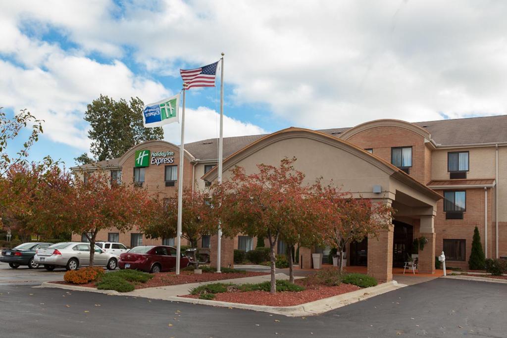 a hotel with an american flag in front of it at Holiday Inn Express Hotel & Suites Canton by IHG in Canton