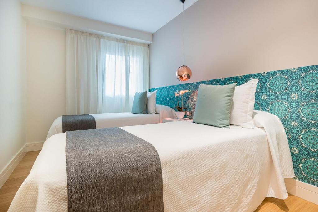 Posteľ alebo postele v izbe v ubytovaní iloftmalaga Premium Calle Nueva
