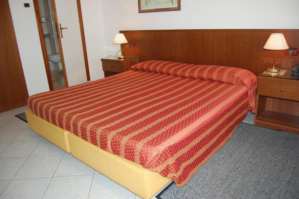Postel nebo postele na pokoji v ubytování Hotel Caldin's