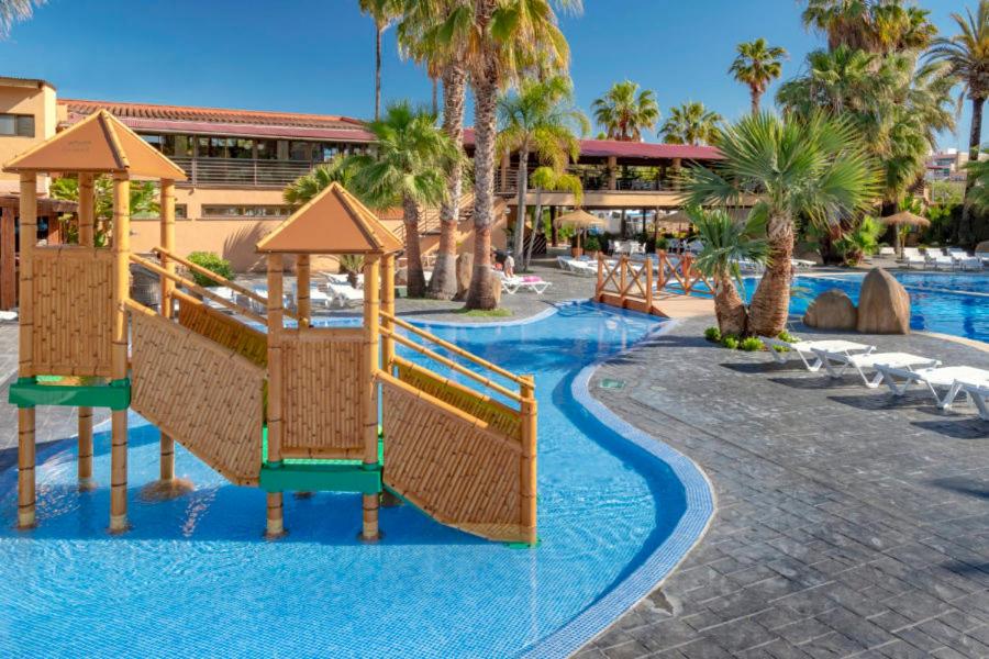 a resort with a slide in the middle of a pool at Camping Enmar in Pineda de Mar
