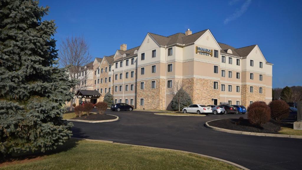 a large building with cars parked in a parking lot at Staybridge Suites - Cincinnati North, an IHG Hotel in West Chester