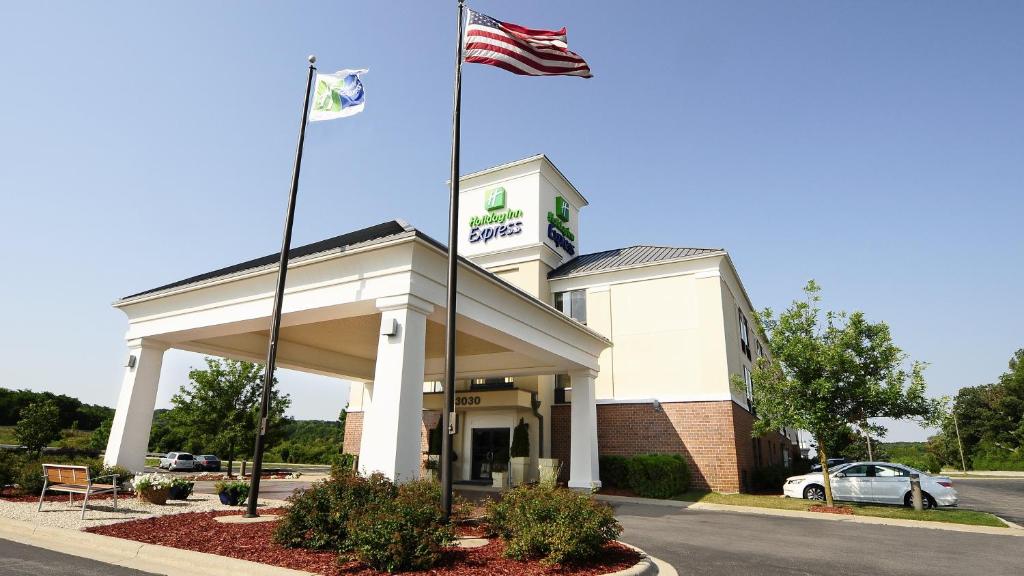 a building with two flags on top of it at Holiday Inn Express - Delafield, an IHG Hotel in Delafield