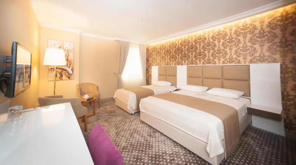 Кровать или кровати в номере Boris Hotel Beylikdüzü