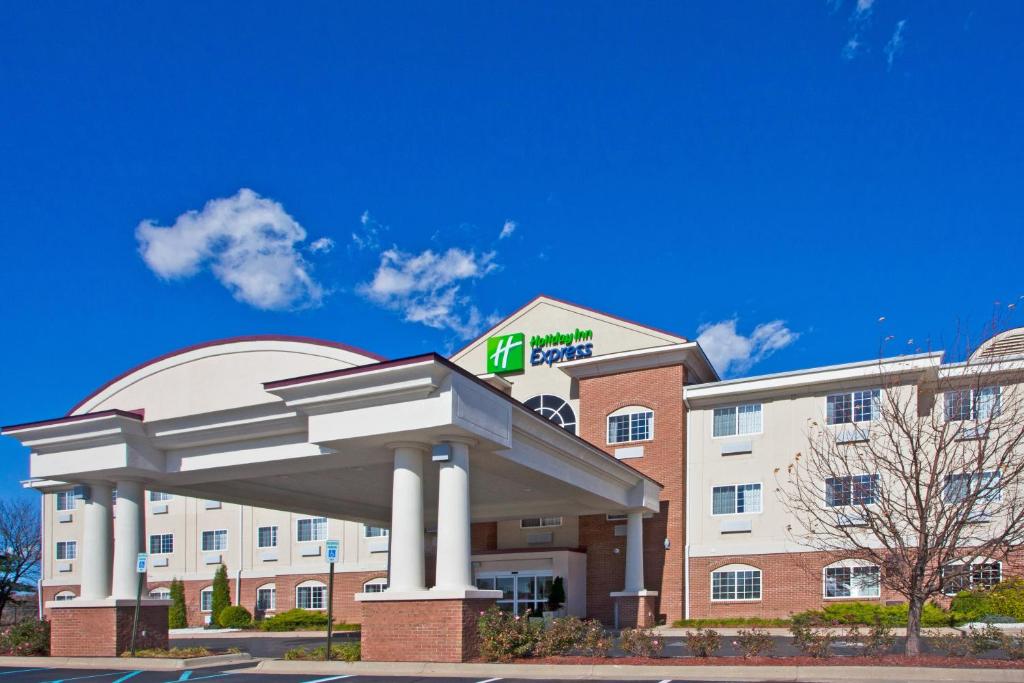 a hotel building with a sign on the front of it at Holiday Inn Express Hotel & Suites Charlotte, an IHG Hotel in Charlotte