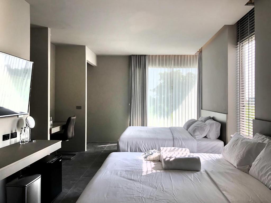 Postel nebo postele na pokoji v ubytování Doowall Hotel