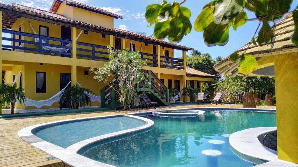 a swimming pool in front of a building at Pousada Oceano in Caraíva