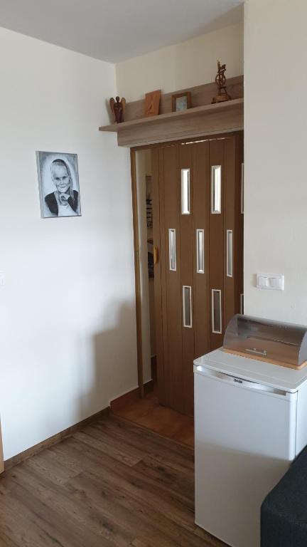 a laundry room with a washer and dryer next to a door at Apartman BibKa in Donovaly