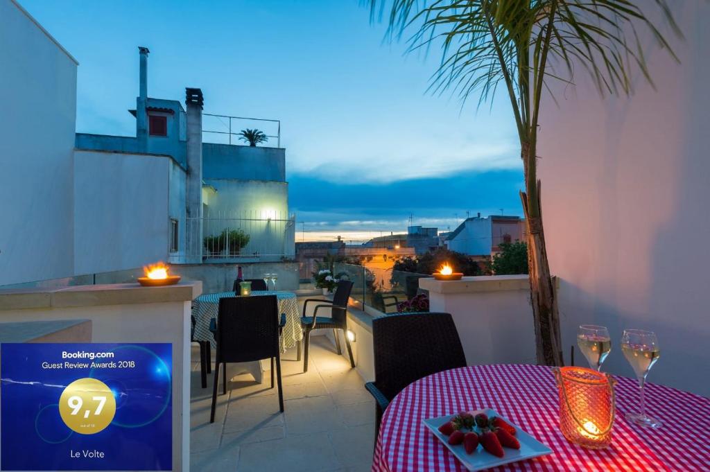 a table with a plate of food on a balcony at Le Volte in Sannicola