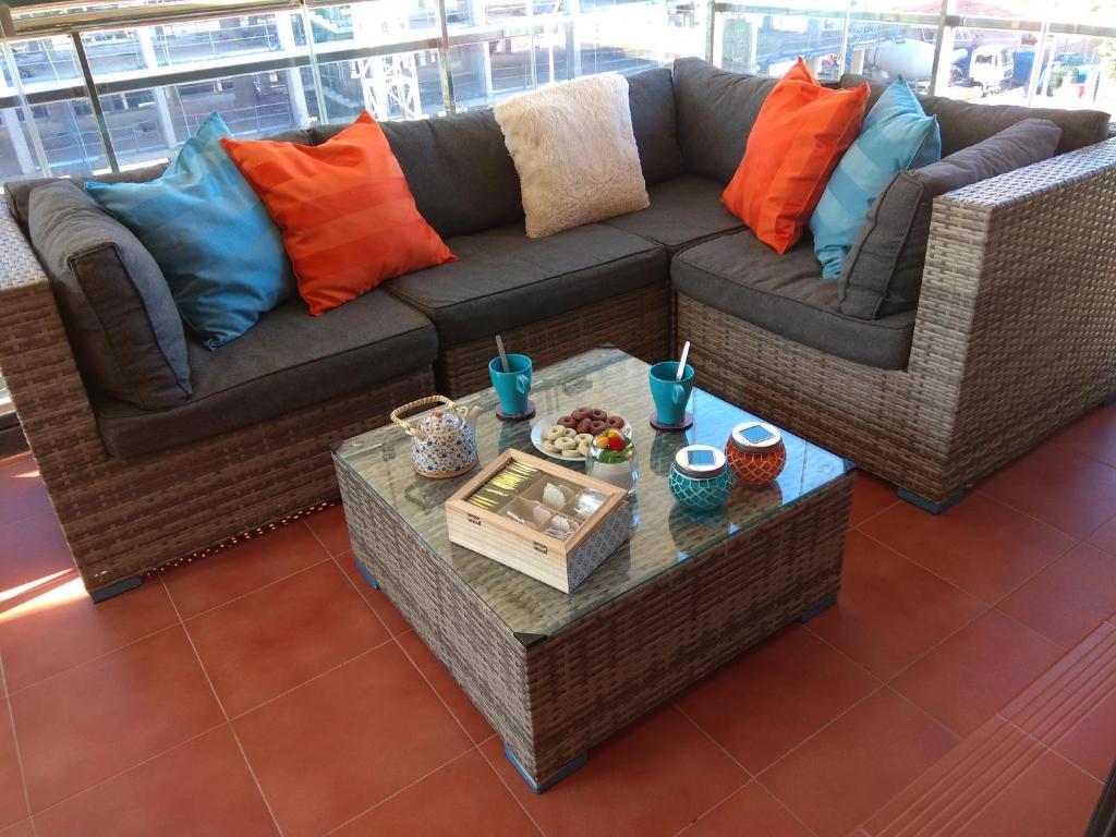 a living room with a couch and a table at Apartamento cerca playa San Juan in Alicante