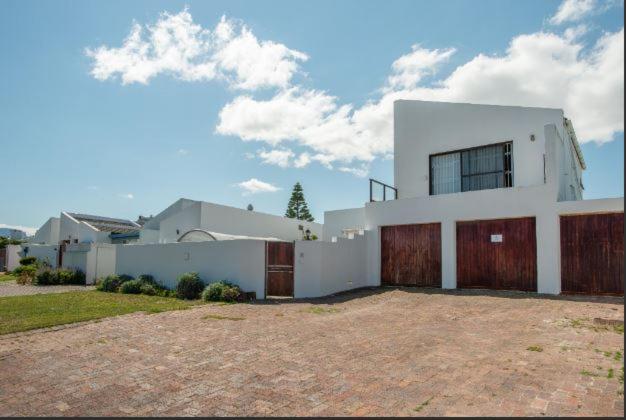 a large white house with a large driveway at Safe, Accessible Venue Near Muizenberg for Accommodation and Events in Cape Town