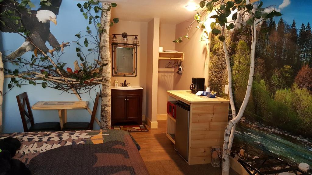 a bathroom with a sink and a mirror at Bear Cove Inn in Saint Ignace
