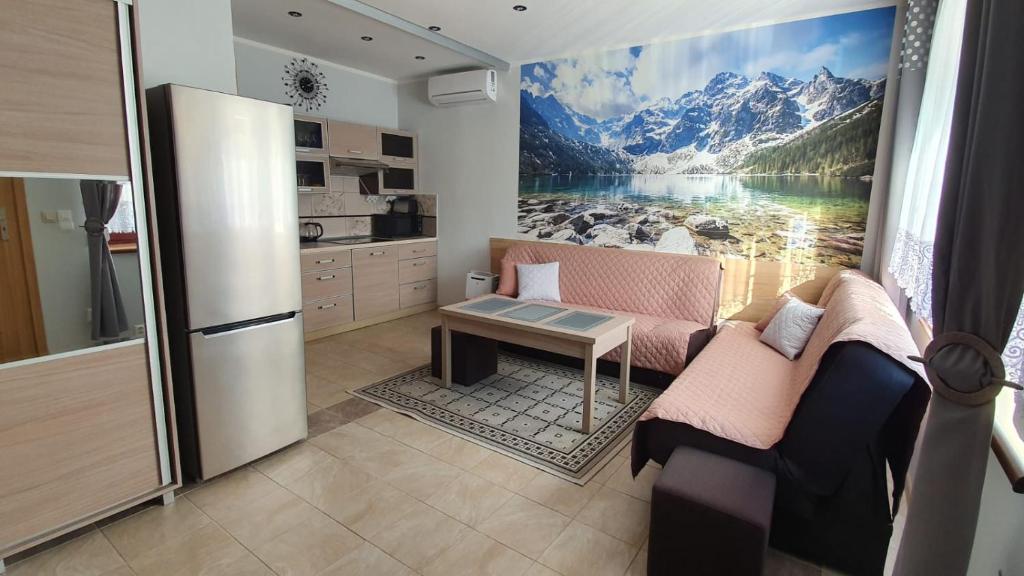 a kitchen with a large painting of a mountain at APARTAMENCIK MAJA studio in Kudowa-Zdrój