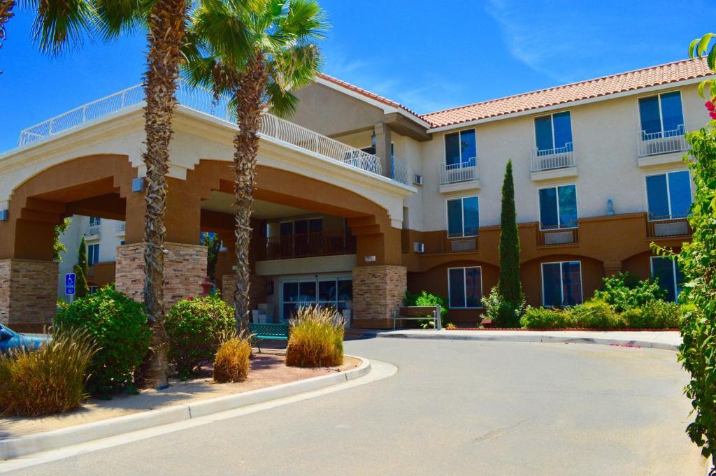 a large building with palm trees in front of it at Holiday Inn Express Calexico, an IHG Hotel in Calexico