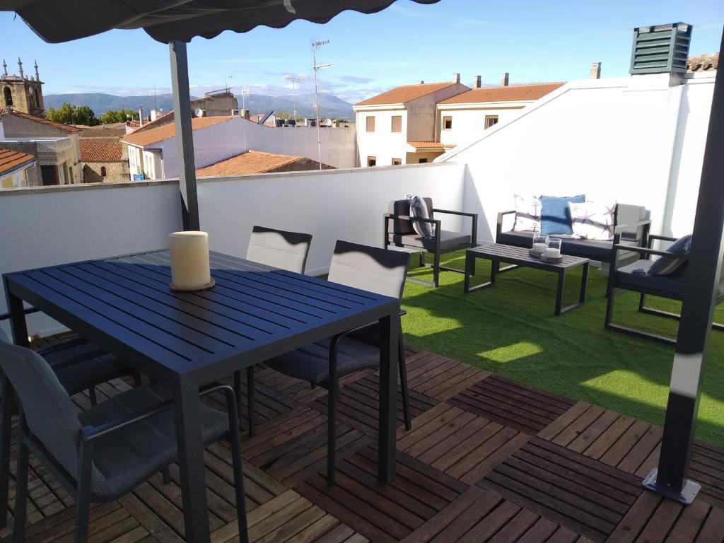 a blue table and chairs on a rooftop deck at Duplex Jalama II in Moraleja