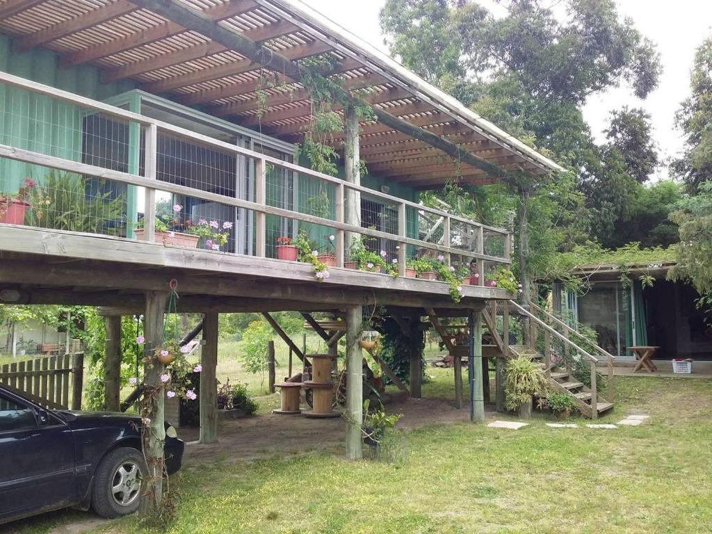 una casa con una terraza con macetas. en Naturaleza pura en Rocha