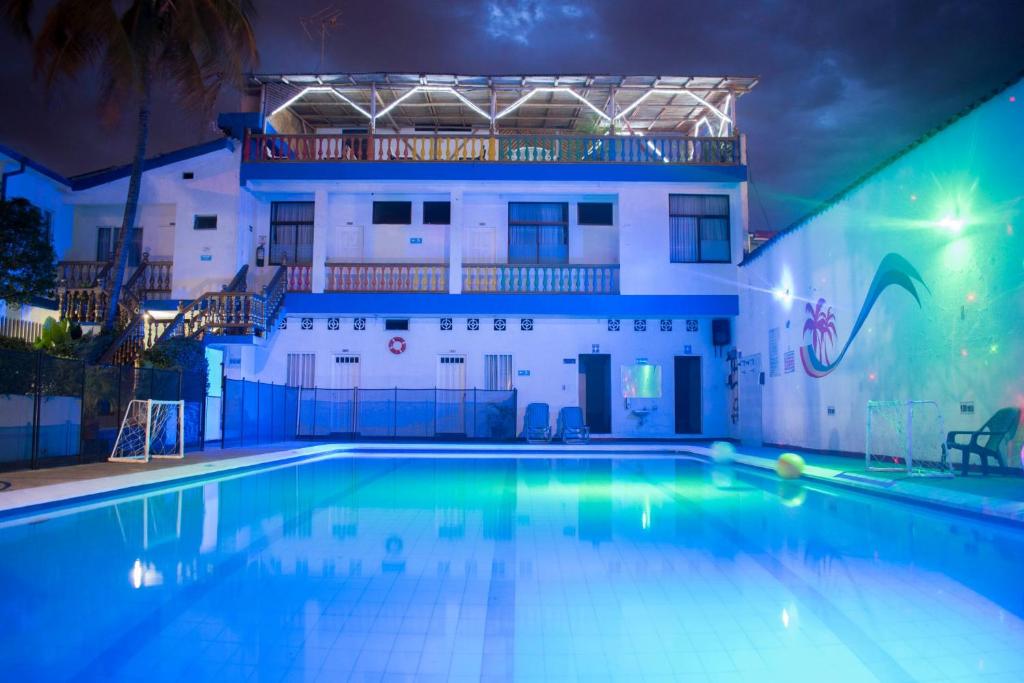- une piscine en face d'un bâtiment la nuit dans l'établissement Hotel Joohn Gay only LGBTIQ, à Melgar