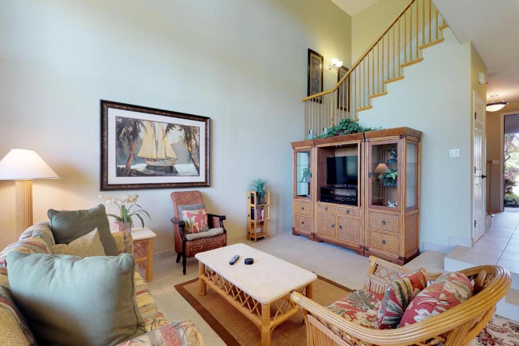 a living room with a couch and a tv at Waikoloa Colony Villas #1104 in Waikoloa