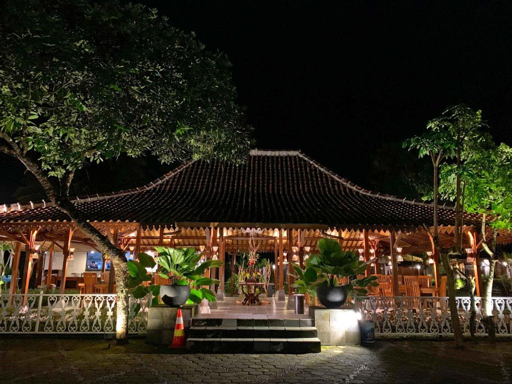 a building with a roof with plants in front of it at The Nalaya Hotel & Resto in Borobudur