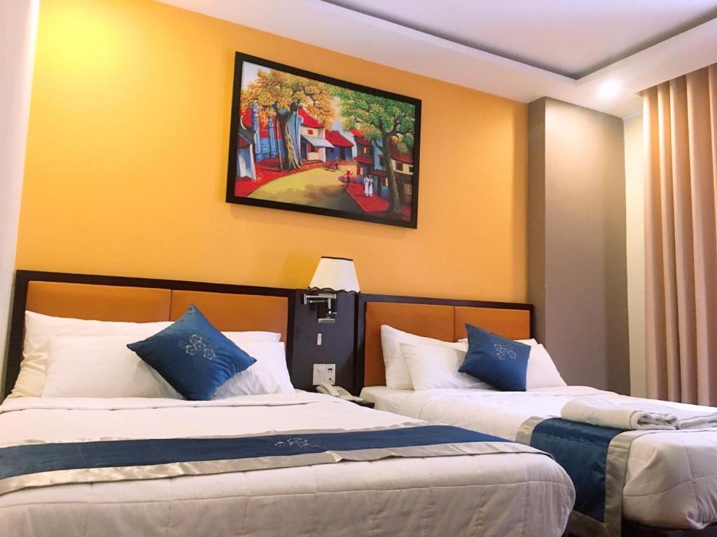 Giường trong phòng chung tại Aladin Hotel