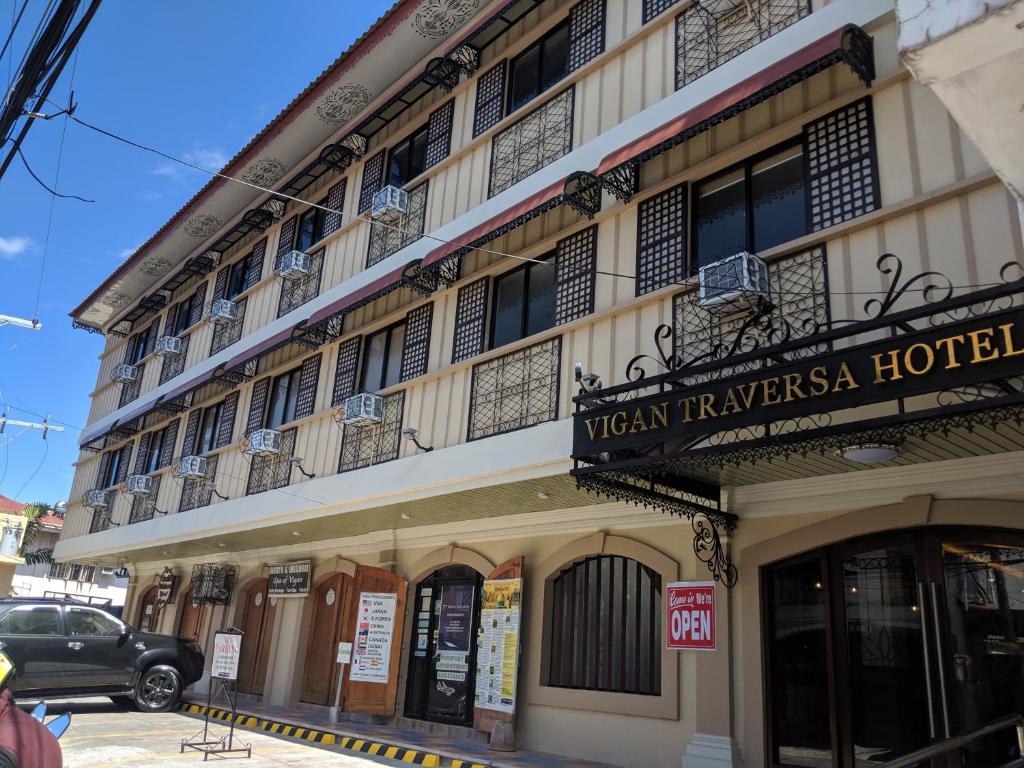 a building with a sign for a hotel at Vigan Traversa Hotel in Vigan