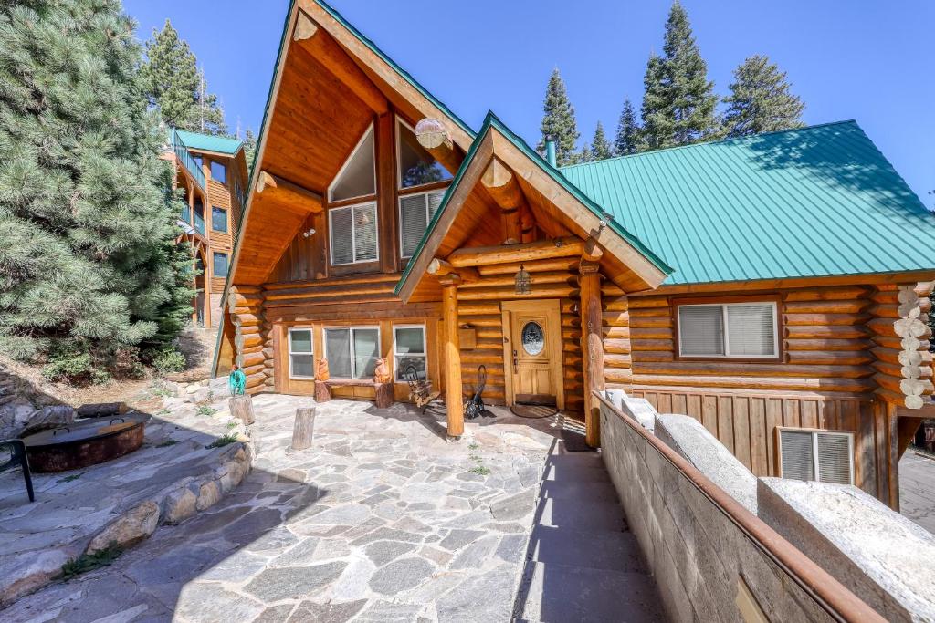 a log home with a pathway leading to the front door at Regatta Chalet in Lakeshore