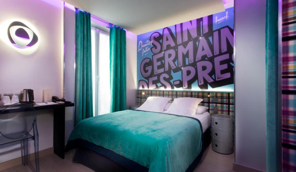 a bedroom with a bed with a large poster on the wall at Hôtel WYLD Saint Germain ex Hotel Moderne Saint Germain in Paris