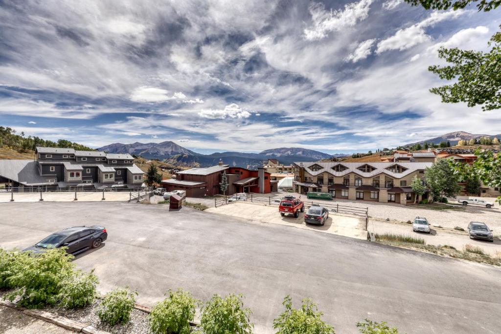 an empty parking lot in a small town with mountains at Beautiful Mountain View Condo in Crested Butte