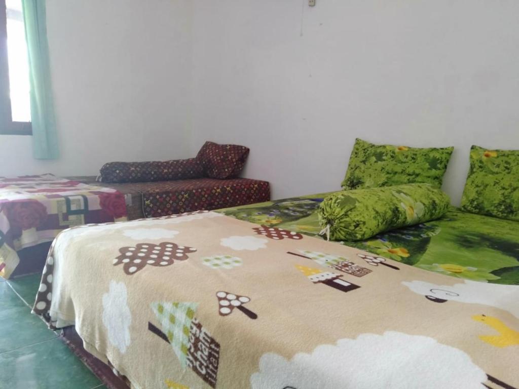 Postel nebo postele na pokoji v ubytování ADELYA HOMESTAY