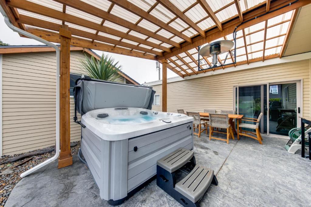 a hot tub on the patio of a house at Wecoma Beach Retreat in Lincoln City